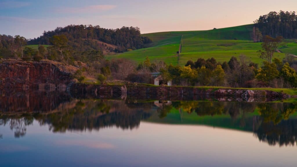Tranquil Australian landscape with reflective water at dusk.