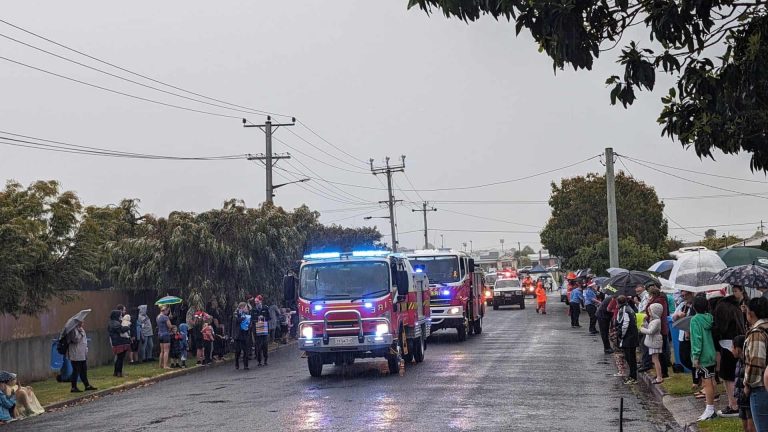 Rainy day with fire trucks and onlookers in Australia.
